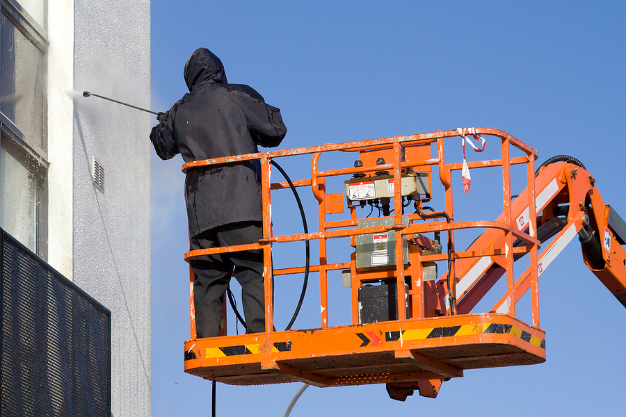 bigstock-Worker-Pressure-Washing-A-Wall-5314041
